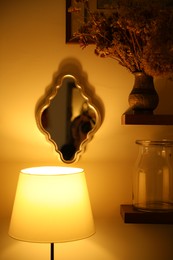 Photo of Lamp, mirror and other decorative elements indoors