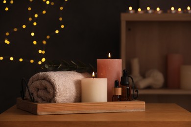 Photo of Beautiful composition with different spa products on wooden table against blurred lights