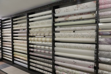 Photo of Assortment of stylish wall papers in shop