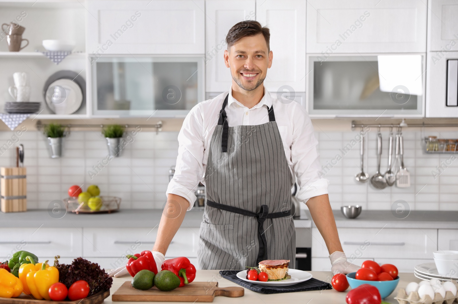Photo of Professional chef in uniform at restaurant kitchen