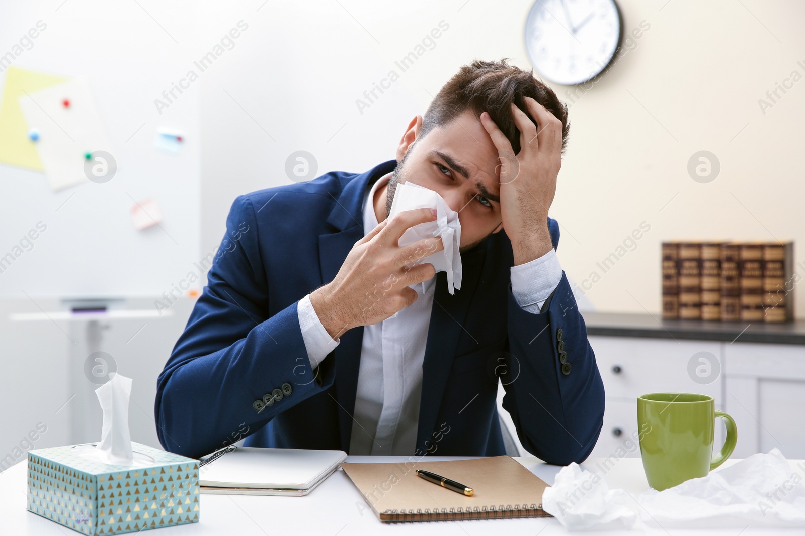 Photo of Sick young man at workplace. Influenza virus