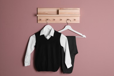 Photo of School uniform for boy hanging on beige wall