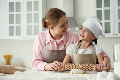 Photo of Mother and daughter cooking together in kitchen