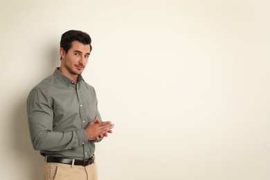 Photo of Young man on beige background. Space for text
