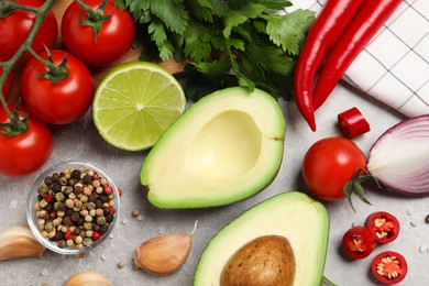 Fresh ingredients for guacamole on light grey table, flat lay