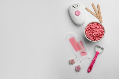 Photo of Set of epilation products on light background, flat lay. Space for text