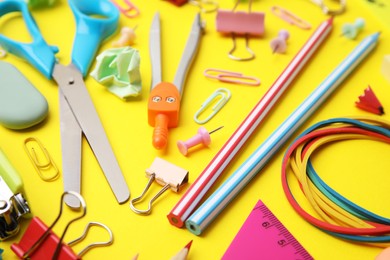 Photo of Different school stationery on yellow background, closeup. Back to school
