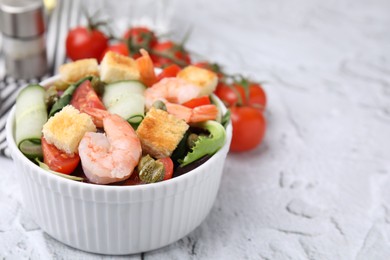 Photo of Tasty salad with croutons, tomato and capers on white textured table, closeup. Space for text