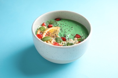 Photo of Bowl of spirulina smoothie on color background