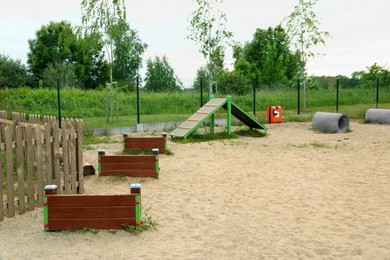 Photo of Wooden rover jump over, king of hill and doggie crawls on animal training area outdoors