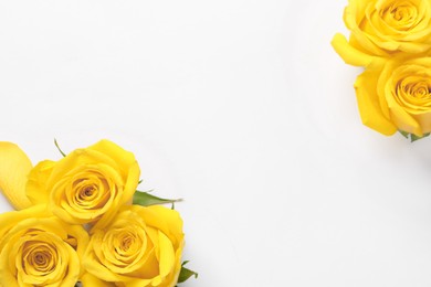 Photo of Beautiful yellow roses on white background, flat lay. Space for text