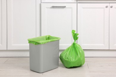 Photo of Plastic garbage bag and trash can in kitchen