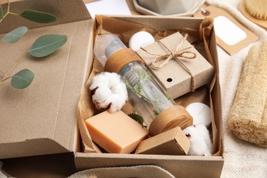 Photo of Box with eco friendly personal care products on fabric