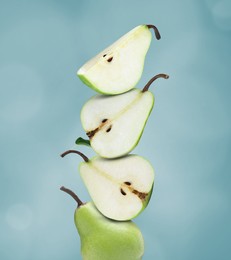 Image of Cut and whole fresh ripe pears on dark turquoise background