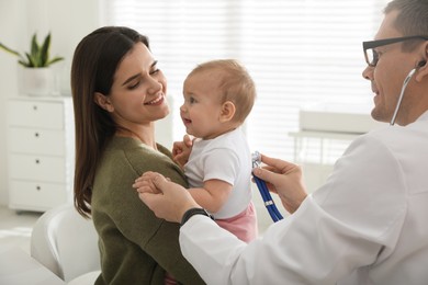 Mother with her cute baby visiting pediatrician in clinic