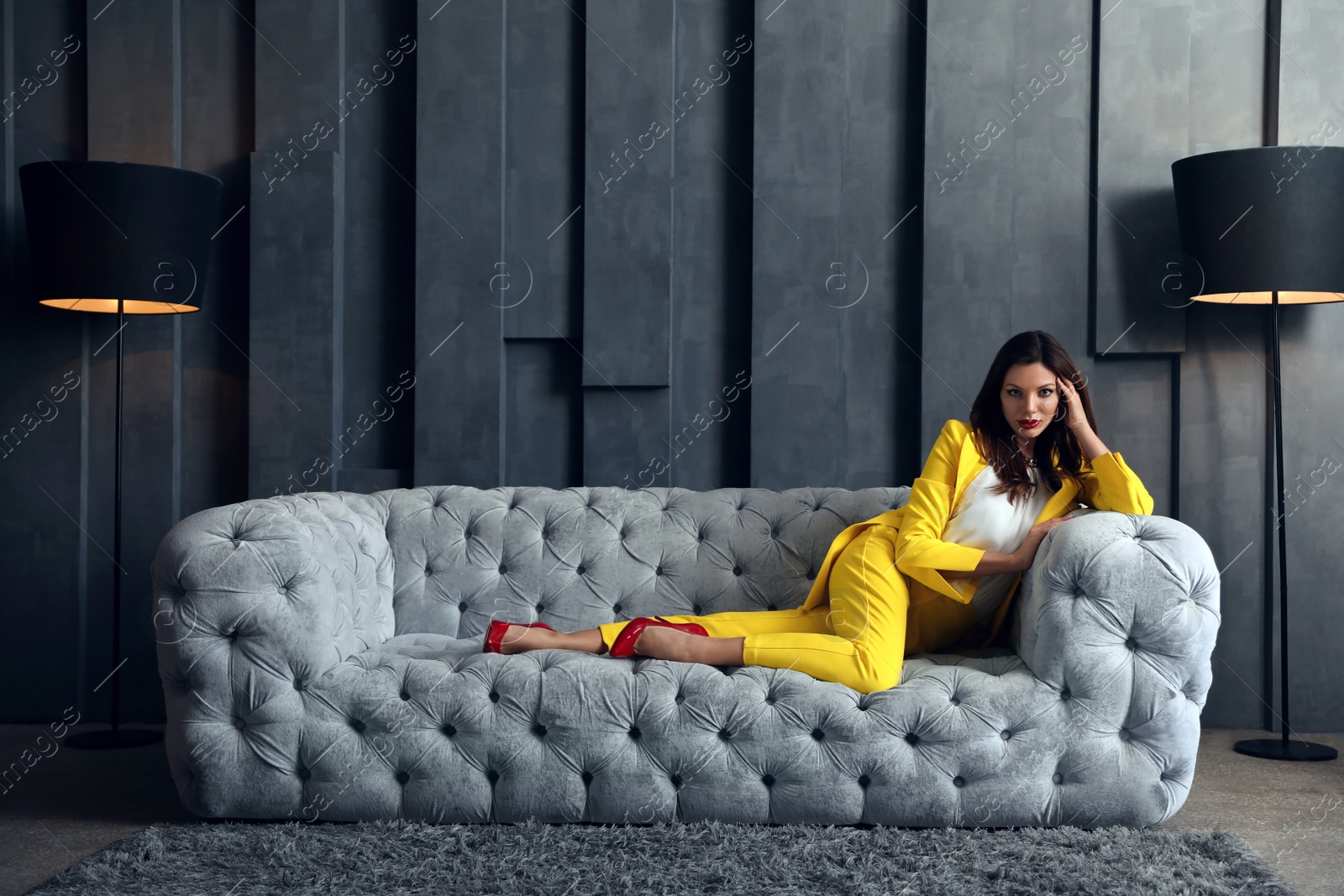 Photo of Beautiful businesswoman on sofa indoors. Luxury lifestyle