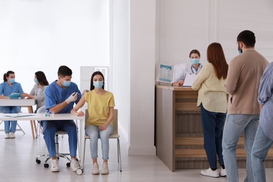 Photo of People waiting for vaccination in line at hospital