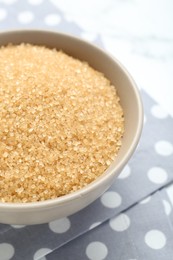 Photo of Brown sugar in bowl on table, closeup