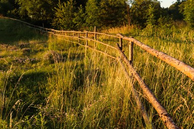 Photo of Picturesque view of countryside with wooden fence in morning