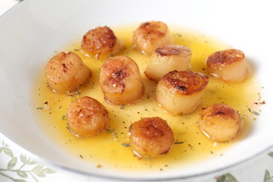 Delicious fried scallops with sauce on table, closeup