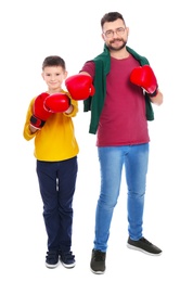 Photo of Little boy and his dad in boxing gloves on white background