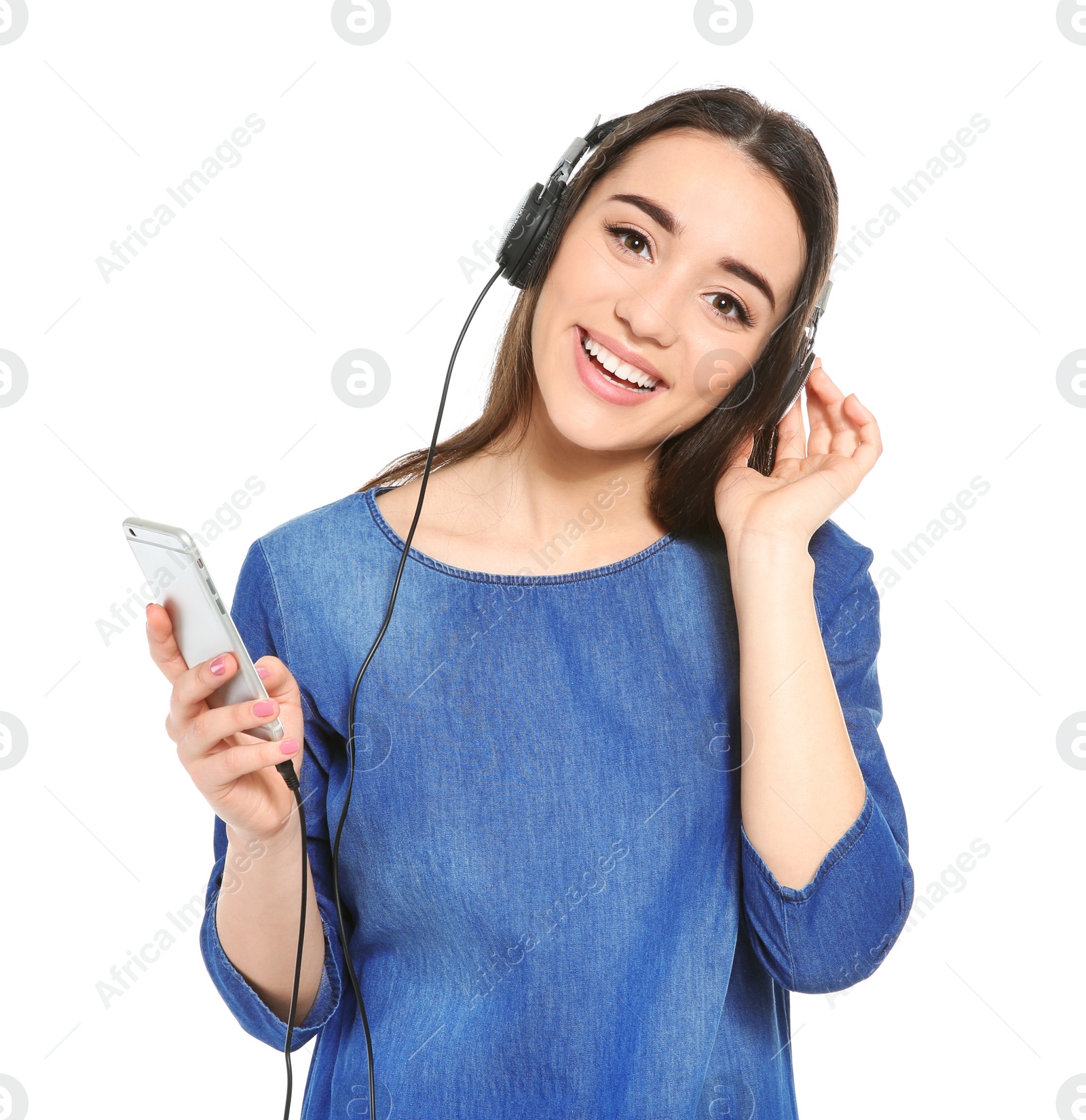 Photo of Beautiful young woman listening to music on mobile phone against white background