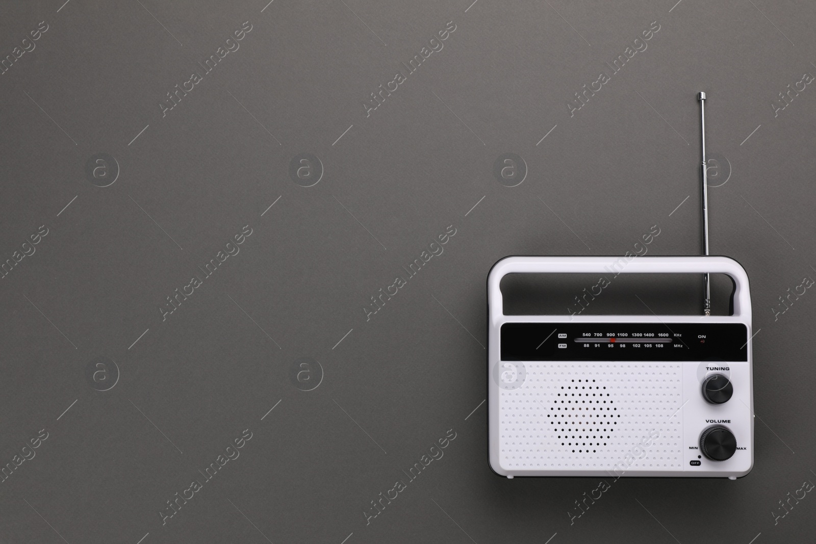 Photo of Retro radio receiver on grey background, top view. Space for text