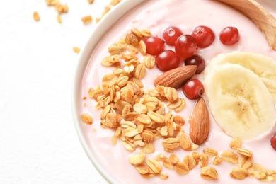 Photo of Bowl with delicious yogurt and granola, closeup