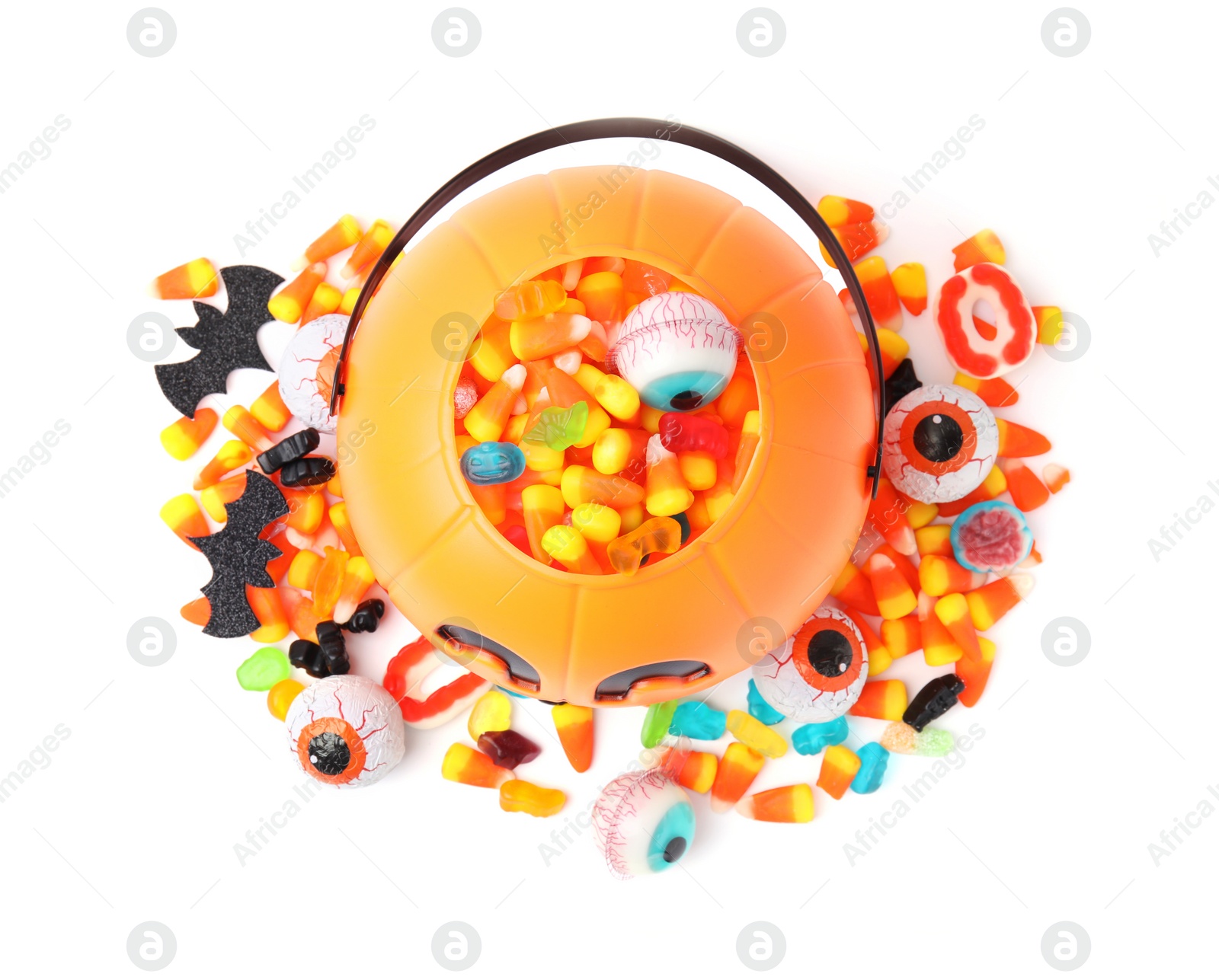 Photo of Halloween trick or treat bucket with different sweets on white background, top view