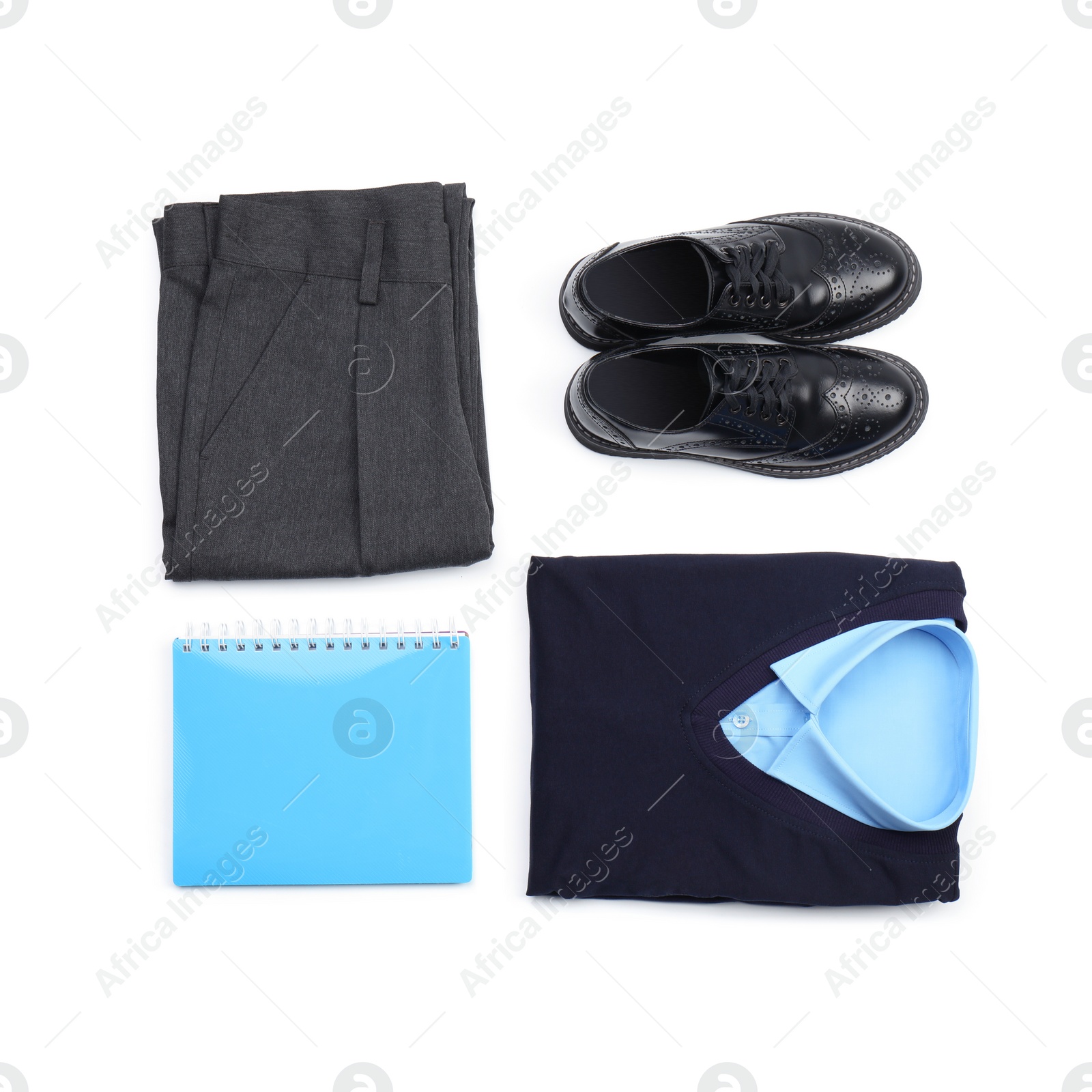 Photo of Stylish school uniform and notebook on white background, top view