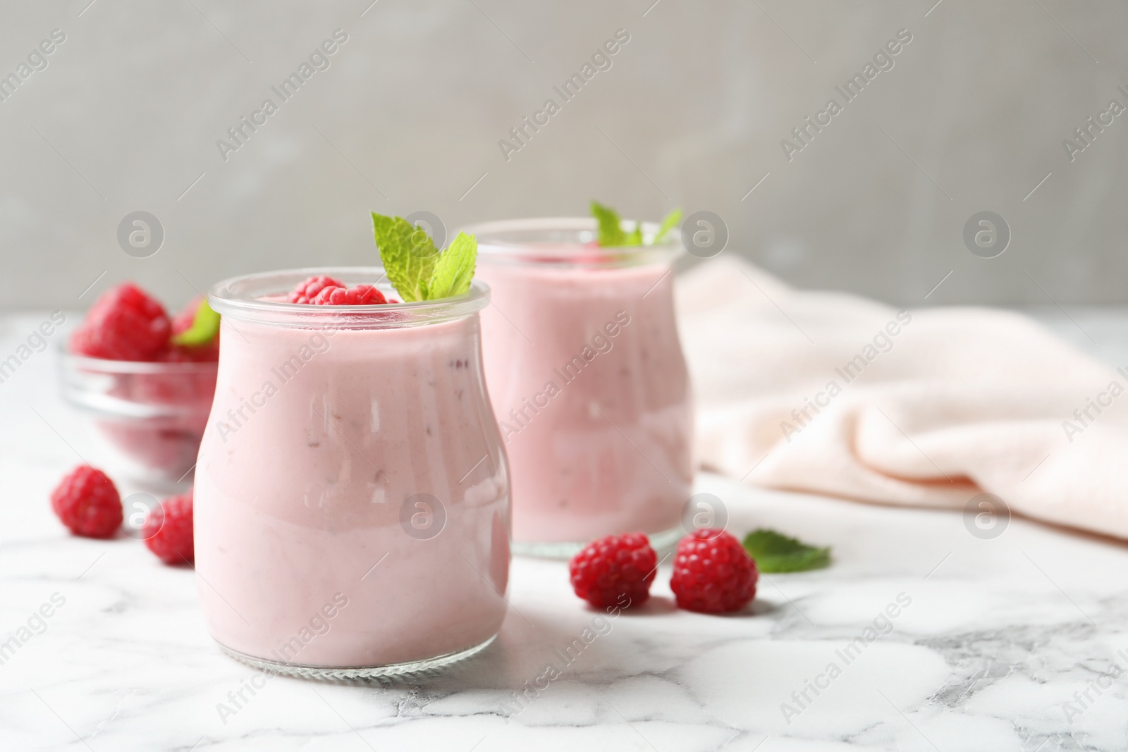 Image of Yummy raspberry smoothie on white marble table