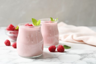 Yummy raspberry smoothie on white marble table