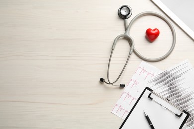 Flat lay composition with stethoscope and red heart on white wooden table, space for text. Cardiology concept