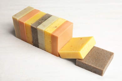 Photo of Hand made soap bars on white wooden background