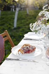 Photo of Stylish table setting with beautiful spring flowers in garden