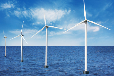 Floating wind turbines installed in sea under blue sky. Alternative energy source 