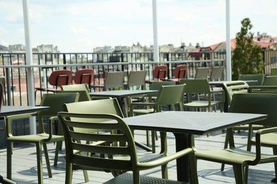 Photo of Observation area cafe. Tables and chairs on terrace against beautiful cityscape