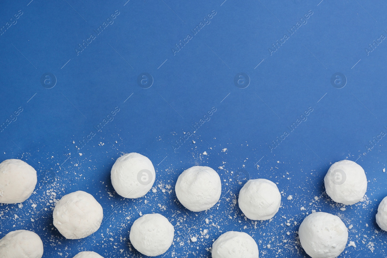 Photo of Snowballs on blue background, flat lay. Space for text