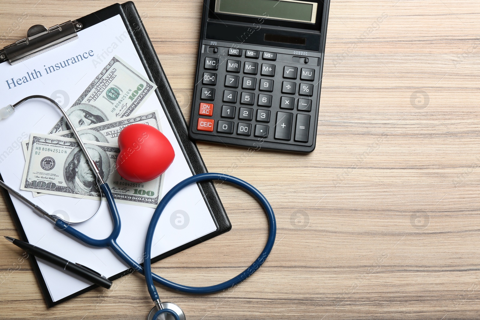 Photo of Flat lay composition with health insurance form, calculator and red heart on wooden background, space for text