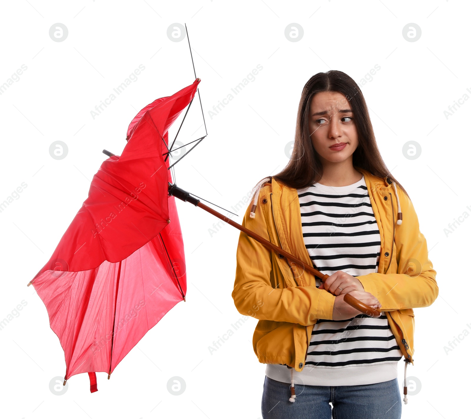 Photo of Emotional woman with umbrella broken by gust of wind on white background