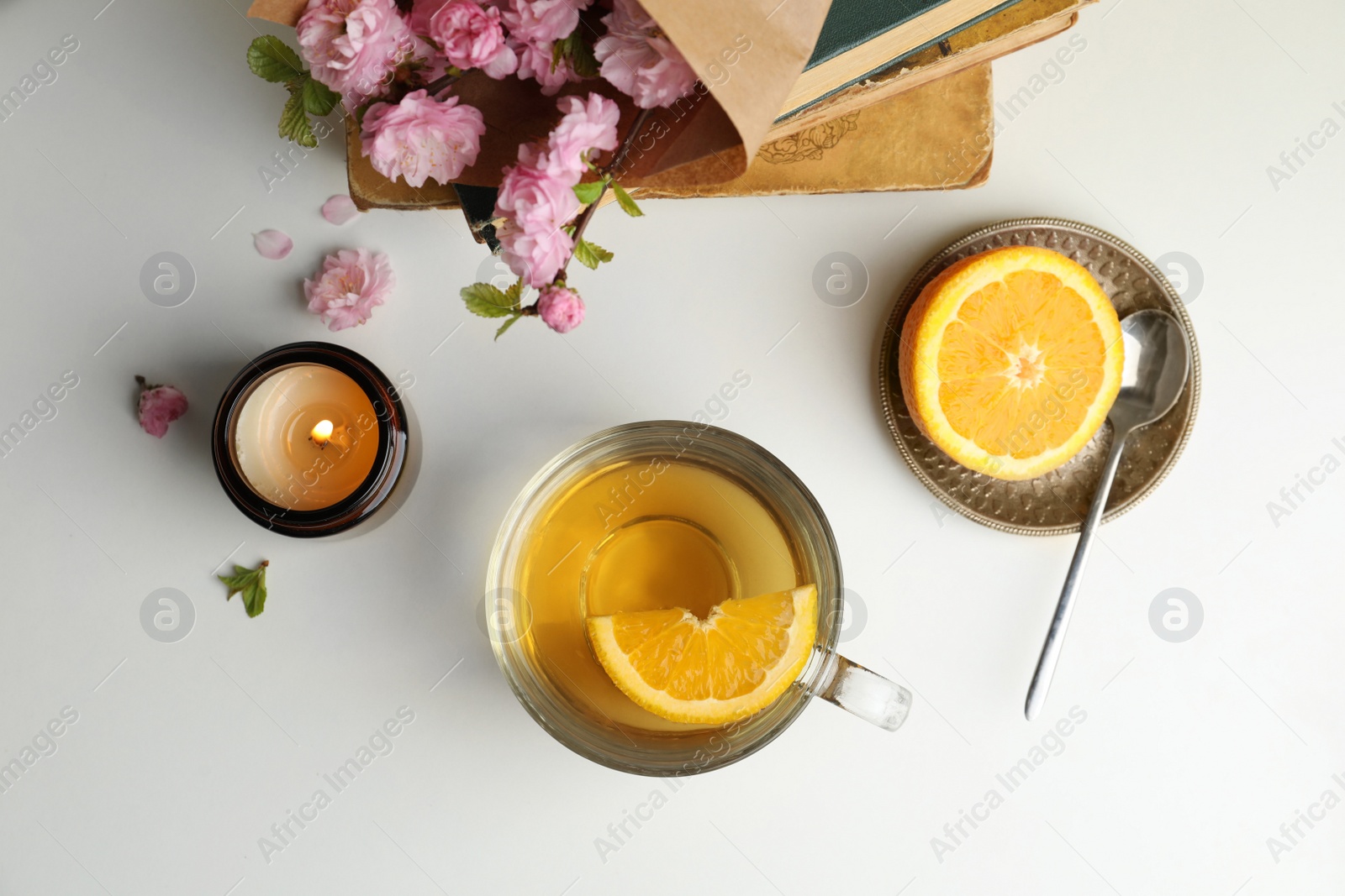 Photo of Flat lay composition with cup of freshly brewed tea on light table