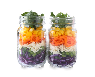 Photo of Healthy salad in glass jars isolated on white