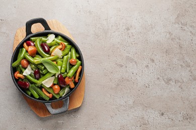 Delicious salad with green beans, mushrooms and cheese on light grey table, top view. Space for text