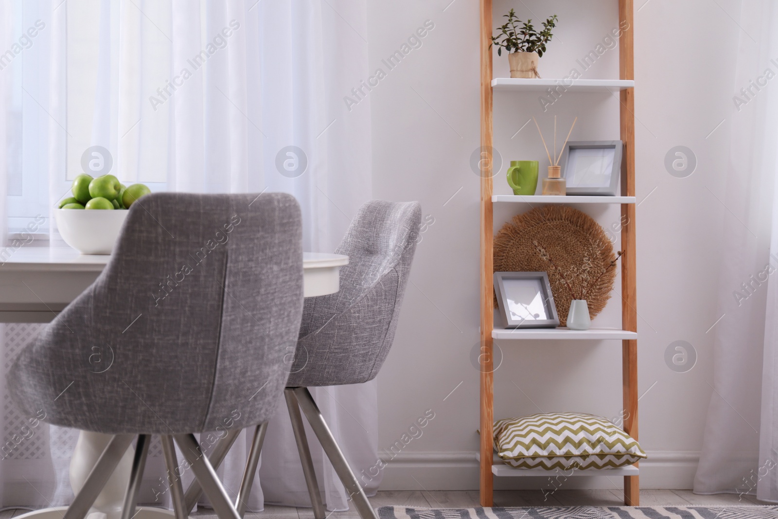 Photo of Stylish living room interior with wooden ladder near white wall