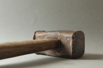 One sledgehammer on grey background, closeup. Manual tool