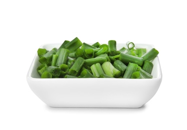 Bowl with chopped green onion on white background