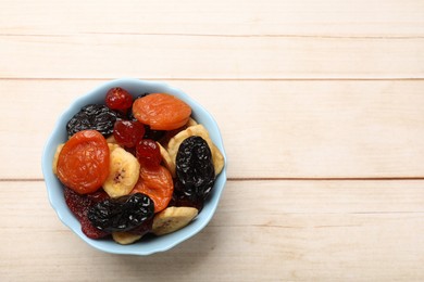 Mix of delicious dried fruits on white wooden table, top view. Space for text