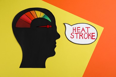 Photo of Human head cutout with temperature conversion chart and words Heat Stroke on color background, flat lay