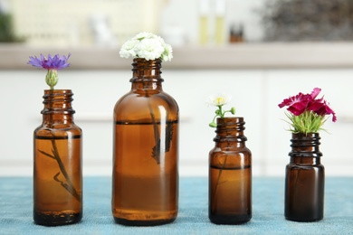 Composition with essential oils and flowers on table