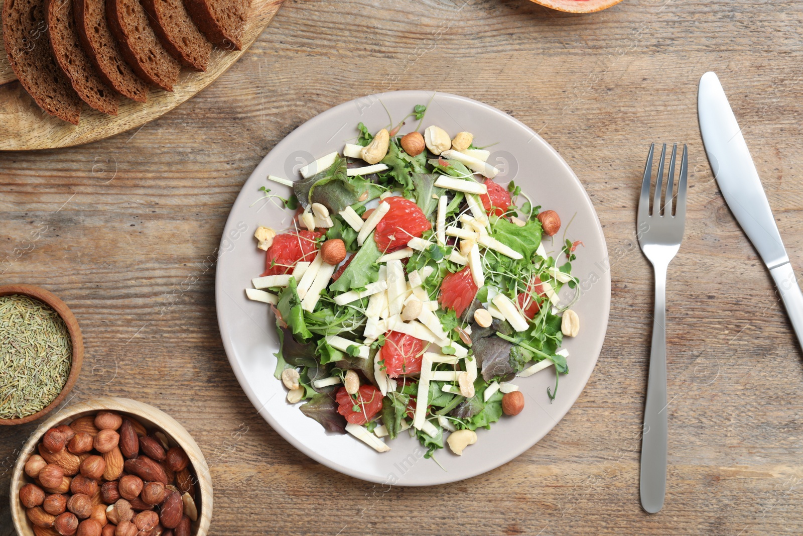 Photo of Delicious carrot salad served on wooden table, flat lay